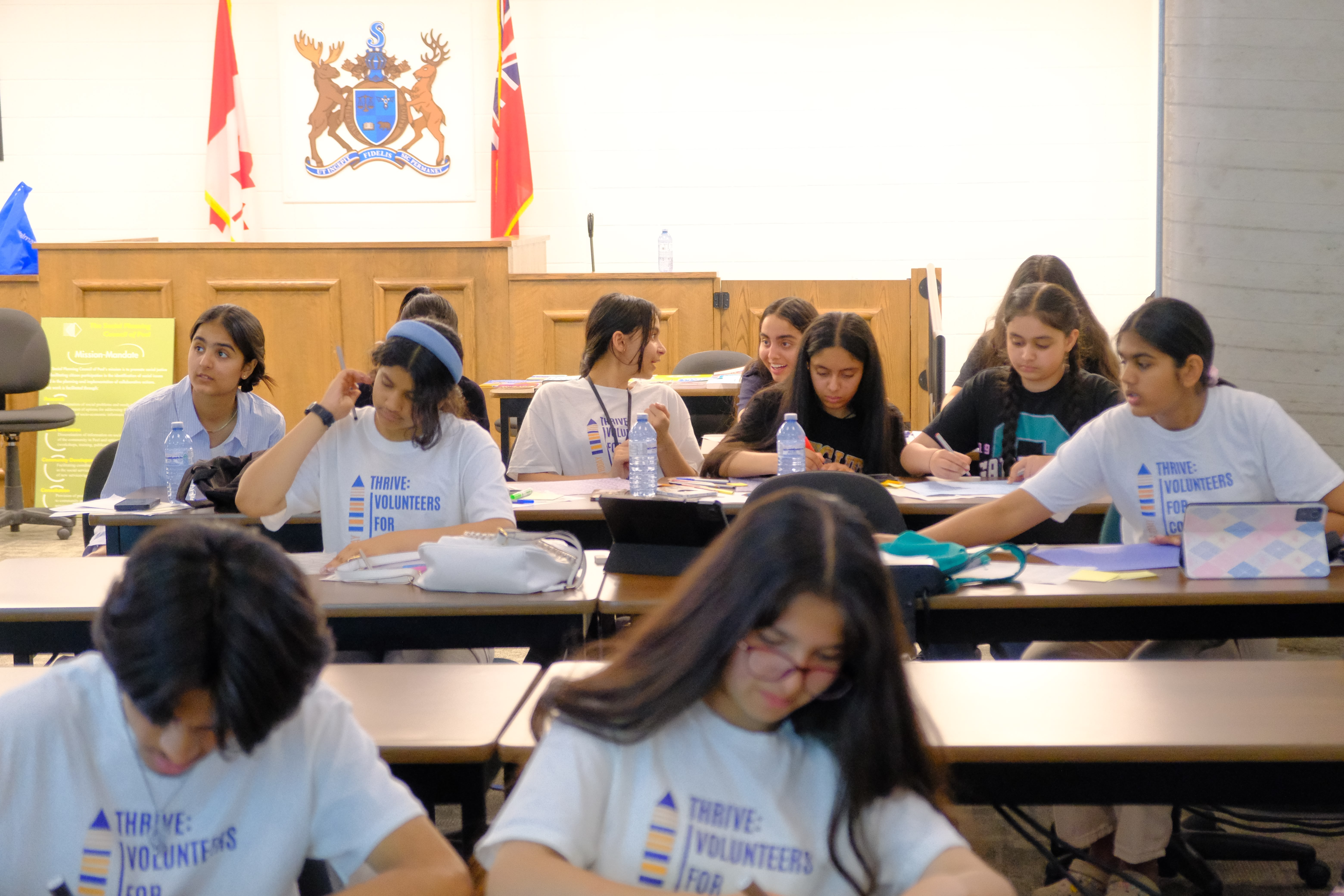 A picture of various youths writing notes during the Learning How to Practice Community Workshop with Dr. Bethany Osborne on June 3, 2025