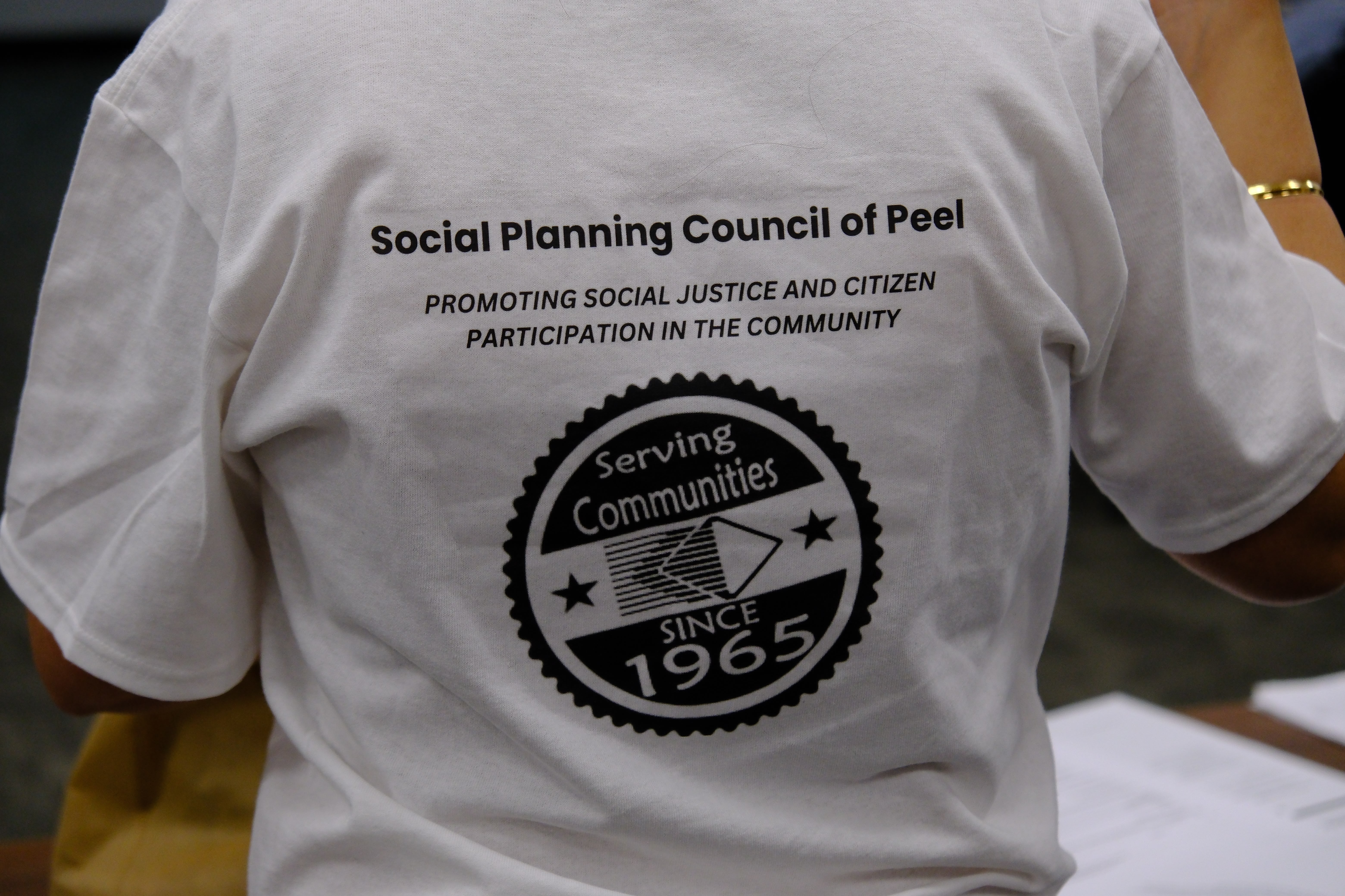 A picture of a t-shirt showing the SPCP logo and mission statement