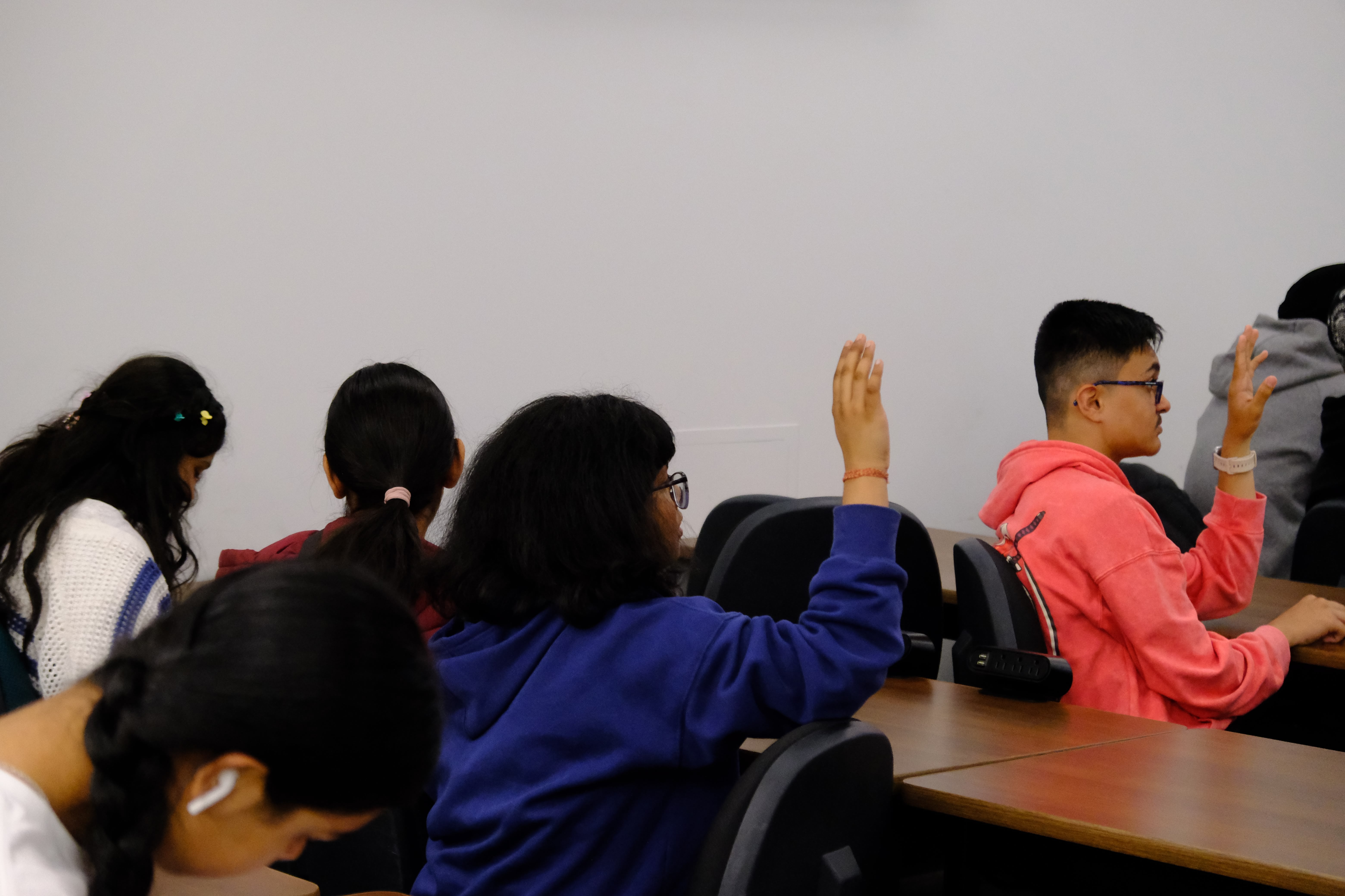 A picture of youths raising their hands to answer questions asked during the Entrepreneurship Basics Workshop on May 24, 2025