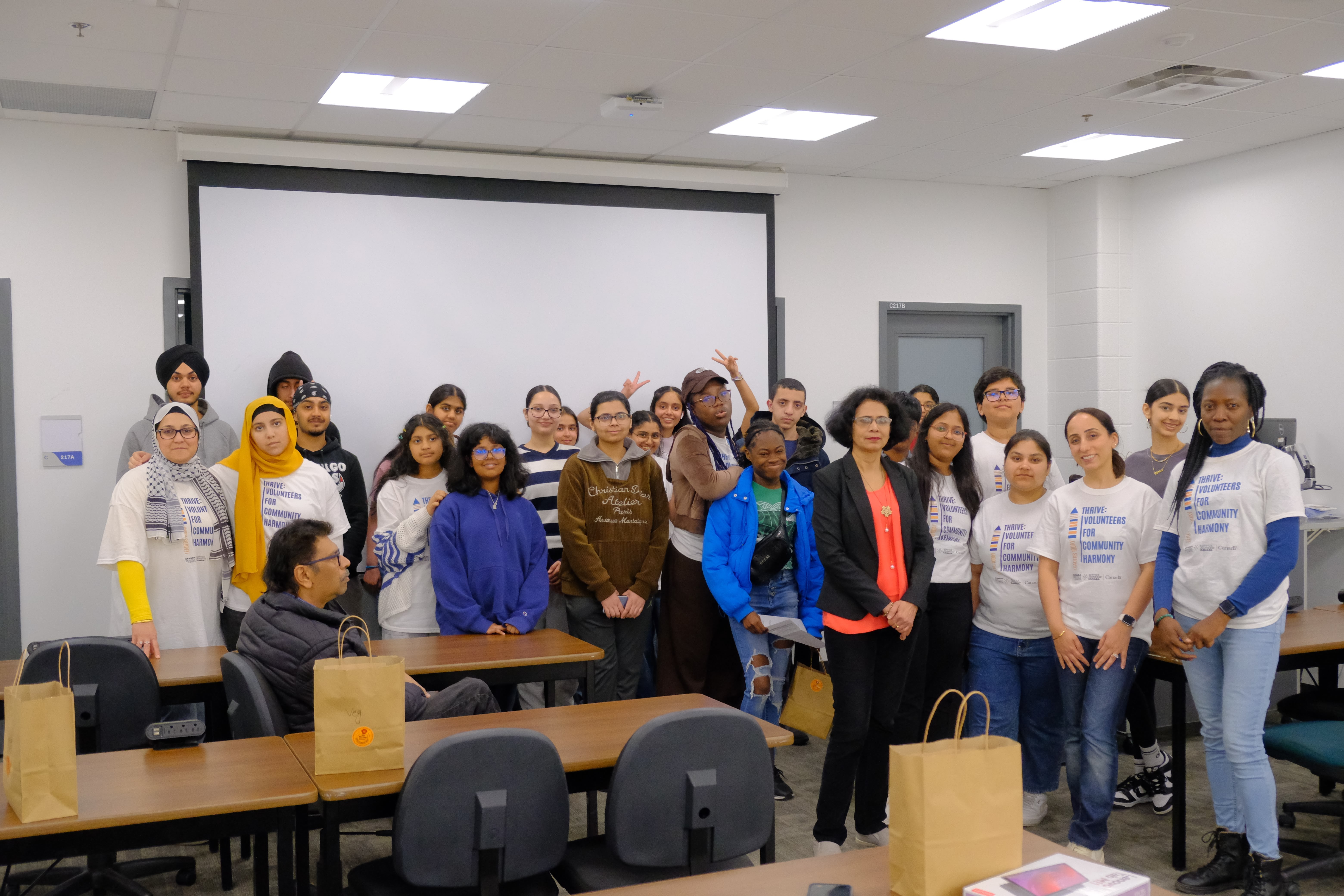 A picture of the SPCP staff, Dr. Sunanda Mishra Panda, and the youths at the Entrepreneurship Basics Workshop explaining to the youths on May 24, 2025