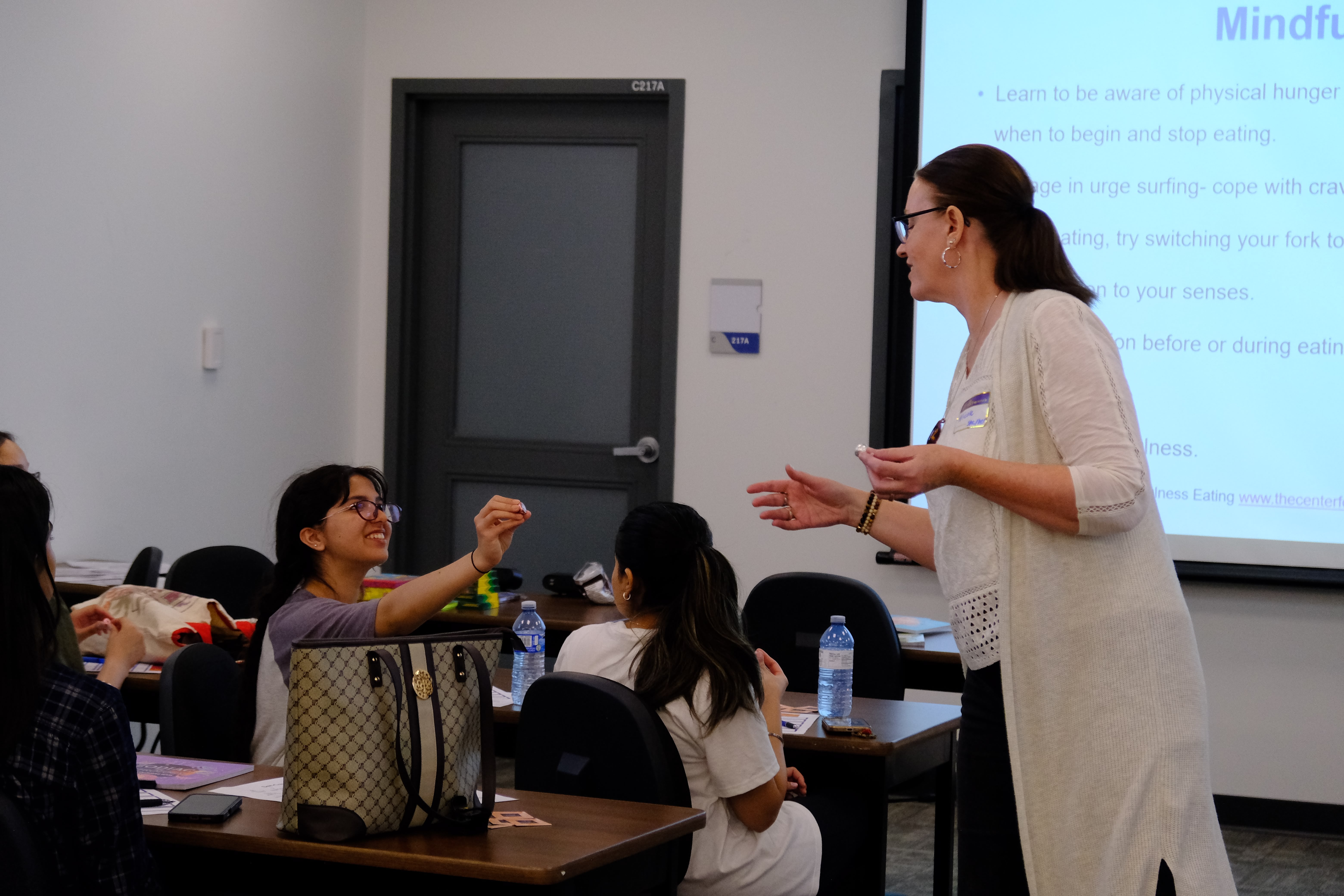 A closeup picture of the Facilitator and a youth interacting during the Mental & Physical Wellness Workshop with Nicole Johnson on May 27, 2025