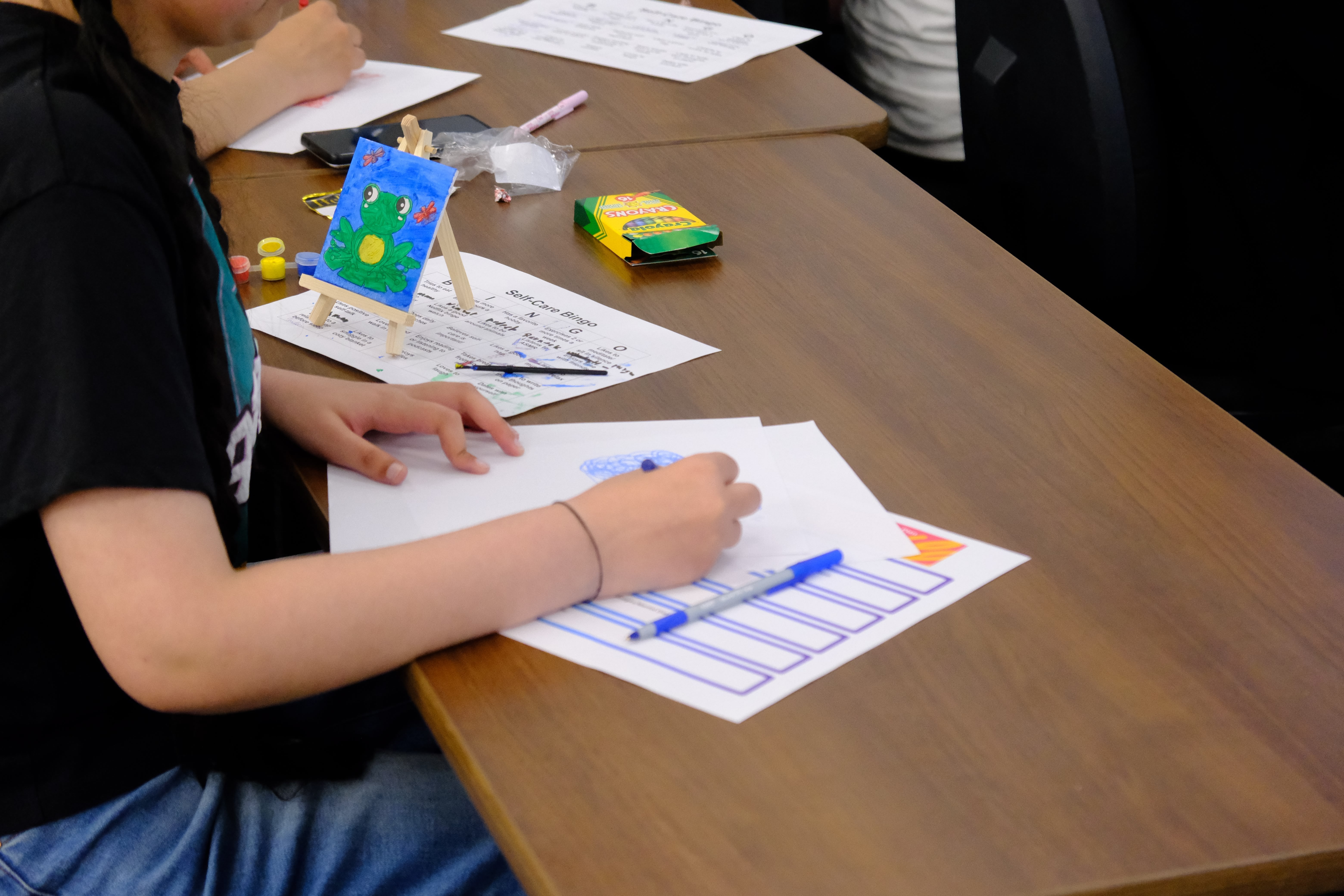 A closeup picture of a youth drawing during the Mental & Physical Wellness Workshop with Nicole Johnson on May 27, 2025
