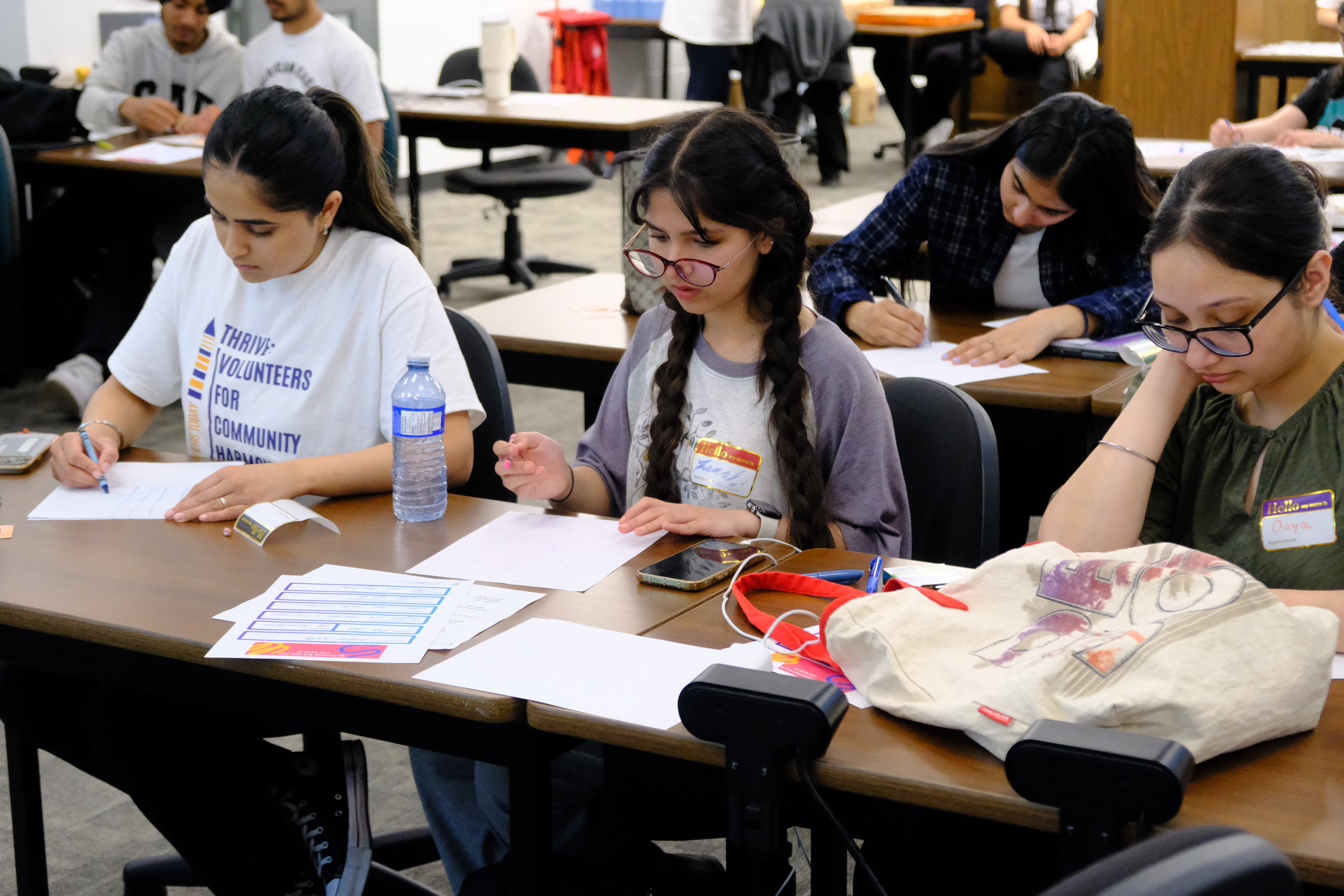 A closeup picture of various youth focused on drawing during the Mental & Physical Wellness Workshop with Nicole Johnson on May 27, 2025