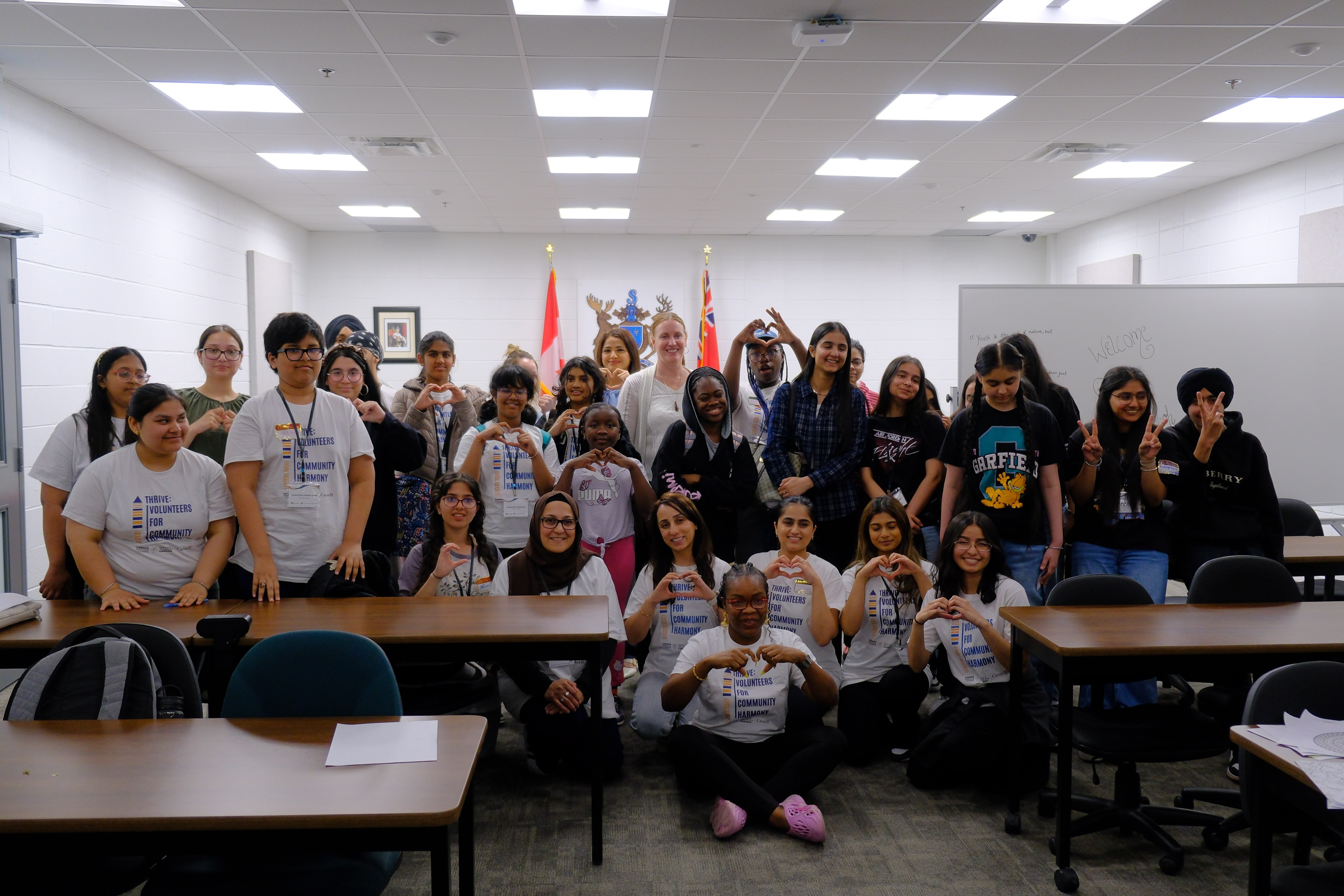 A group picture of all the participating youths and the Facilitator during the Mental & Physical Wellness Workshop with Nicole Johnson on May 27, 2025
