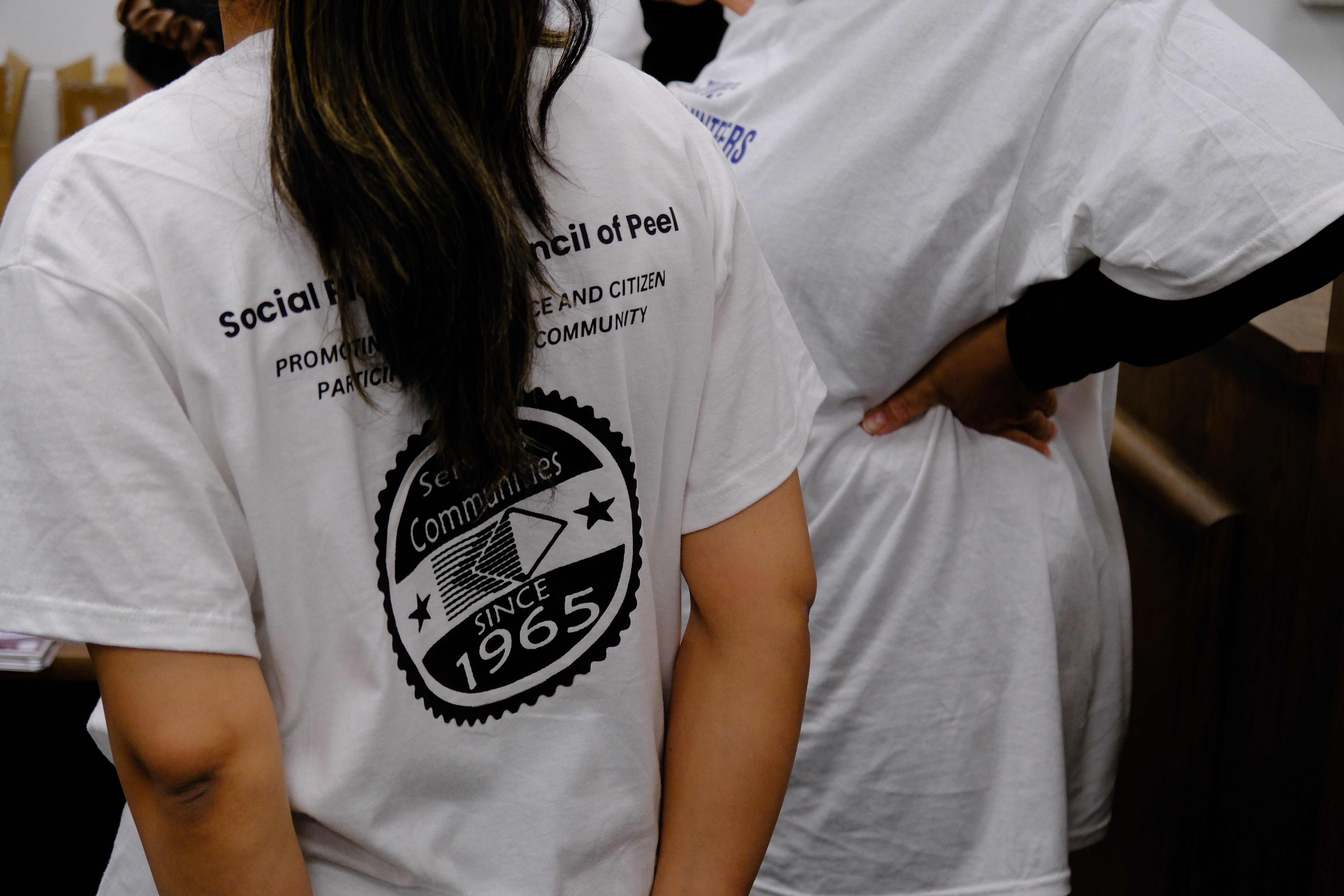 A picture of a SPCP team member wearing a t-shirt with SPCP logo during the Mental & Physical Wellness Workshop with Nicole Johnson on May 27, 2025