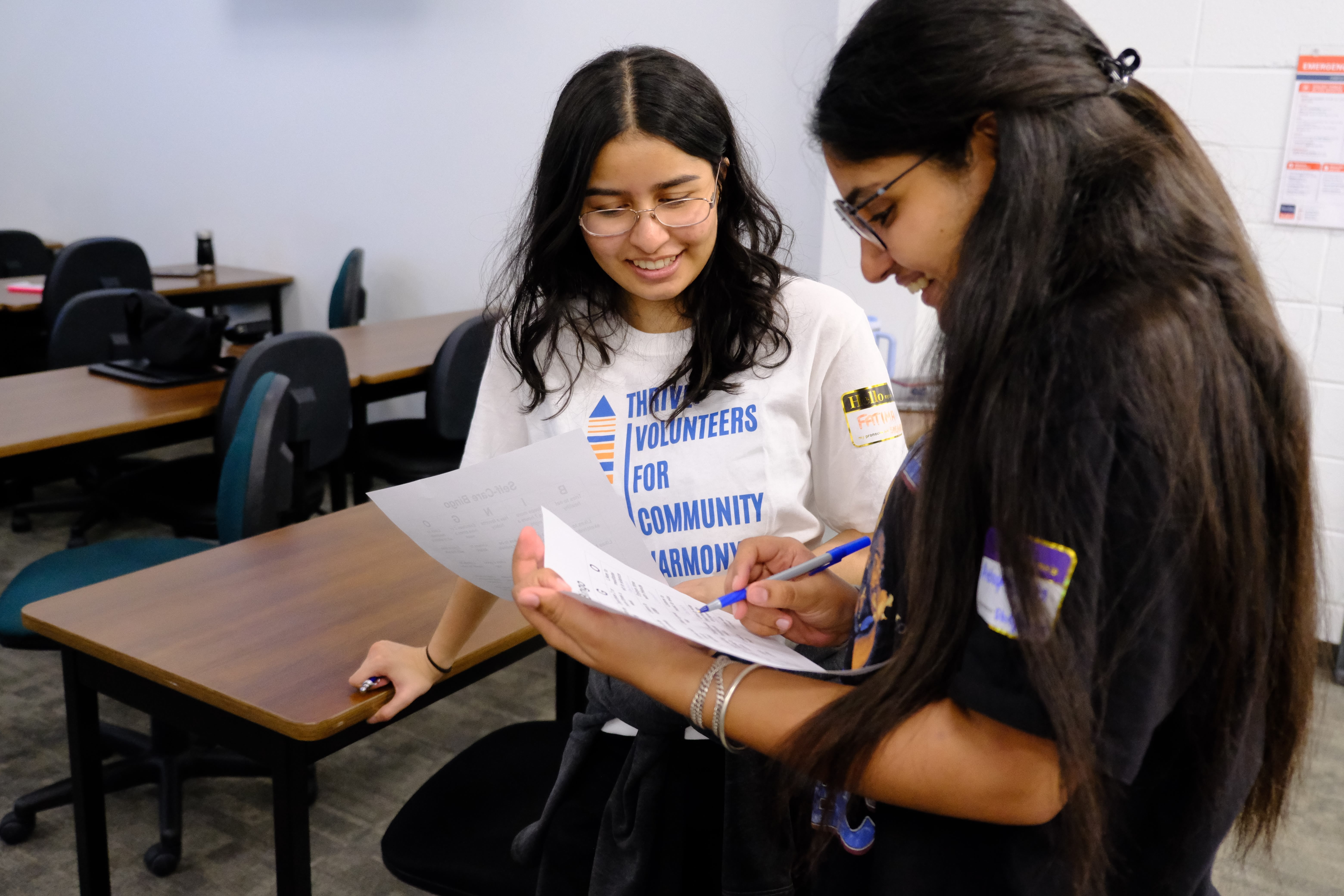 A closeup picture of two youths interacting with each other during the Mental & Physical Wellness Workshop with Nicole Johnson on May 27, 2025