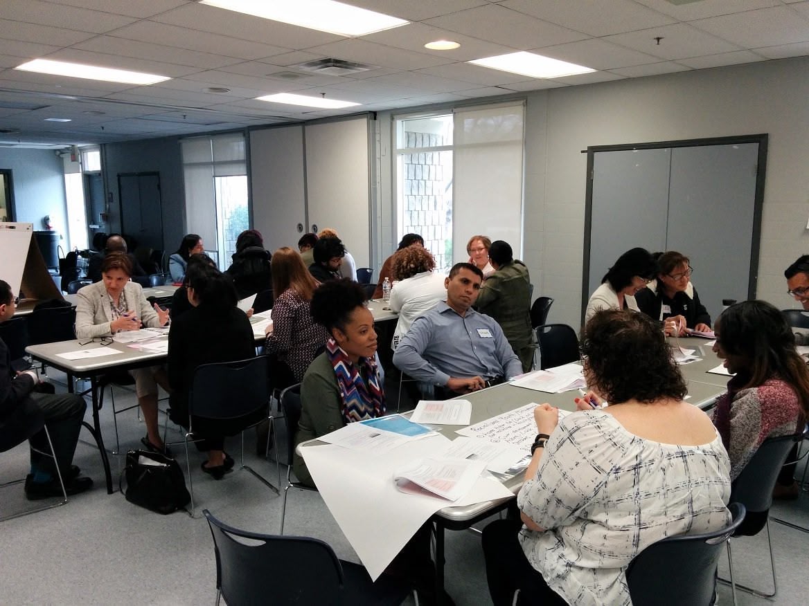A picture of people participating in a seminar on inclusive educational and social services.