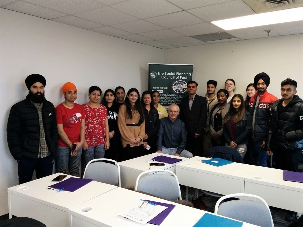 A picture of youths, a facilitator and the SPCP CEO at a professional skill development workshop.